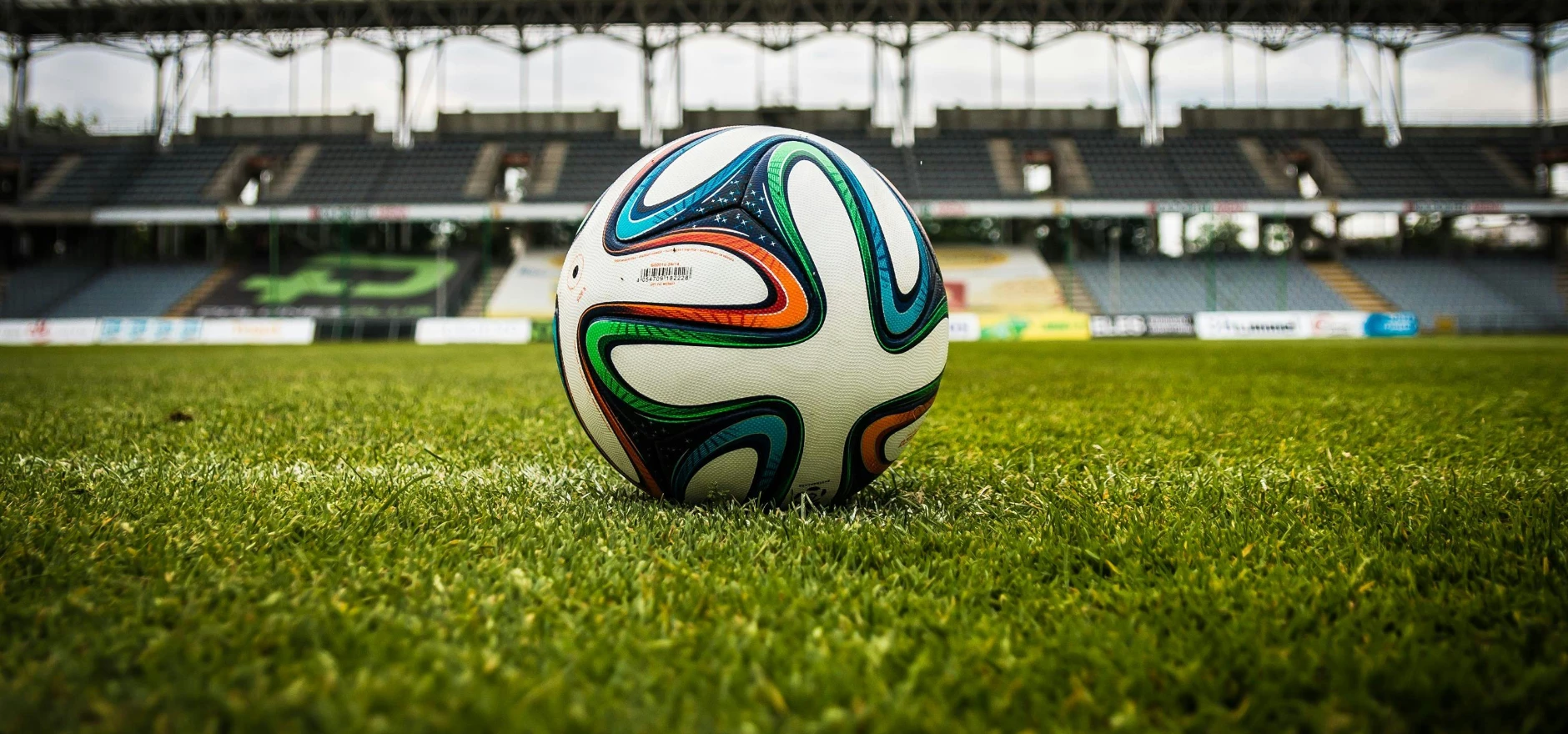 Multicolored Soccer Ball on Green Field